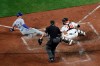 Kansas City Royals' Whit Merrifield (15) scores under the tag of Baltimore Orioles catcher Pedro Severino (28) as home plate umpire Sam Holbrook looks on during the sixth inning of a baseball game, Monday, Aug. 19, 2019, in Baltimore. (AP Photo/Julio Cortez)