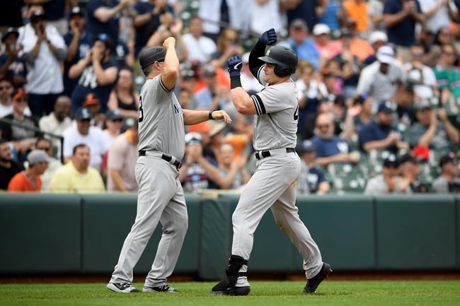 New York Yankees' Luke Voit, right, celebrates his home run with third base coach Phil Nevin (88) during the eighth inning of a baseball game against the Baltimore Orioles, Thursday, May 23, 2019, in Baltimore. The Yankees won 6-5. (AP Photo/Nick Wass)