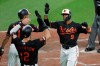 Baltimore Orioles' Keon Broxton (9) is greeted near home plate by Richie Martin (1) and Stevie Wilkerson after hitting a two-run home run off Boston Red Sox starting pitcher David Price during the fourth inning of a baseball game Friday, July 19, 2019, in Baltimore. The Orioles won 11-2. (AP Photo/Julio Cortez)
