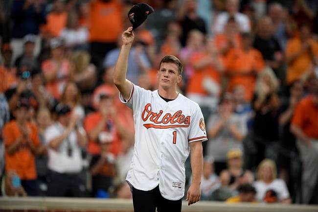 Baltimore Orioles first-round draft pick Adley Rutschman tips his cap to the crowd as he's introduced between innings of a baseball game against the San Diego Padres, Tuesday, June 25, 2019, in Baltimore. (AP Photo/Nick Wass)
