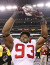 AJ Mast / The Associated Press files
Louis Nzegwu holds the trophy after his Wisconsin Badgers beat Michigan State 42-39 in the Big Ten Conference championship in 2011.