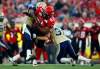 Jeff McIntosh / The Canadian Press
Winnipeg Blue Bombers' Johnny Sears, left, and Ian Logan, right, try to bring down Calgary Stampeders' Nik Lewis during first-quarter CFL  action in Calgary, Alta., Friday.