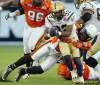 DARRYL DYCK / THE CANADIAN PRESS
Winnipeg Blue Bombers' Fred Reid, centre, runs for an eight-yard gain as B.C. Lions' Solomon Elimimian, right, holds on to bring him down during the first half of a CFL football game in Vancouver, B.C., on Saturday.