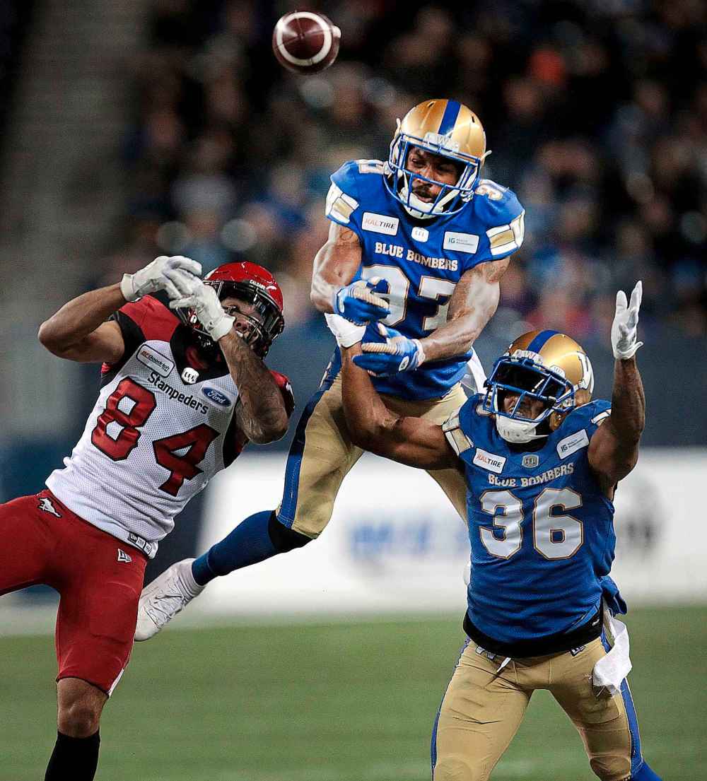 Phil Hossack / Winnipeg Free Press
Airborne Blue Bombers Brandon Alexander and Mercy Maston deny Calgary Stampeders' Reggie Begelton.