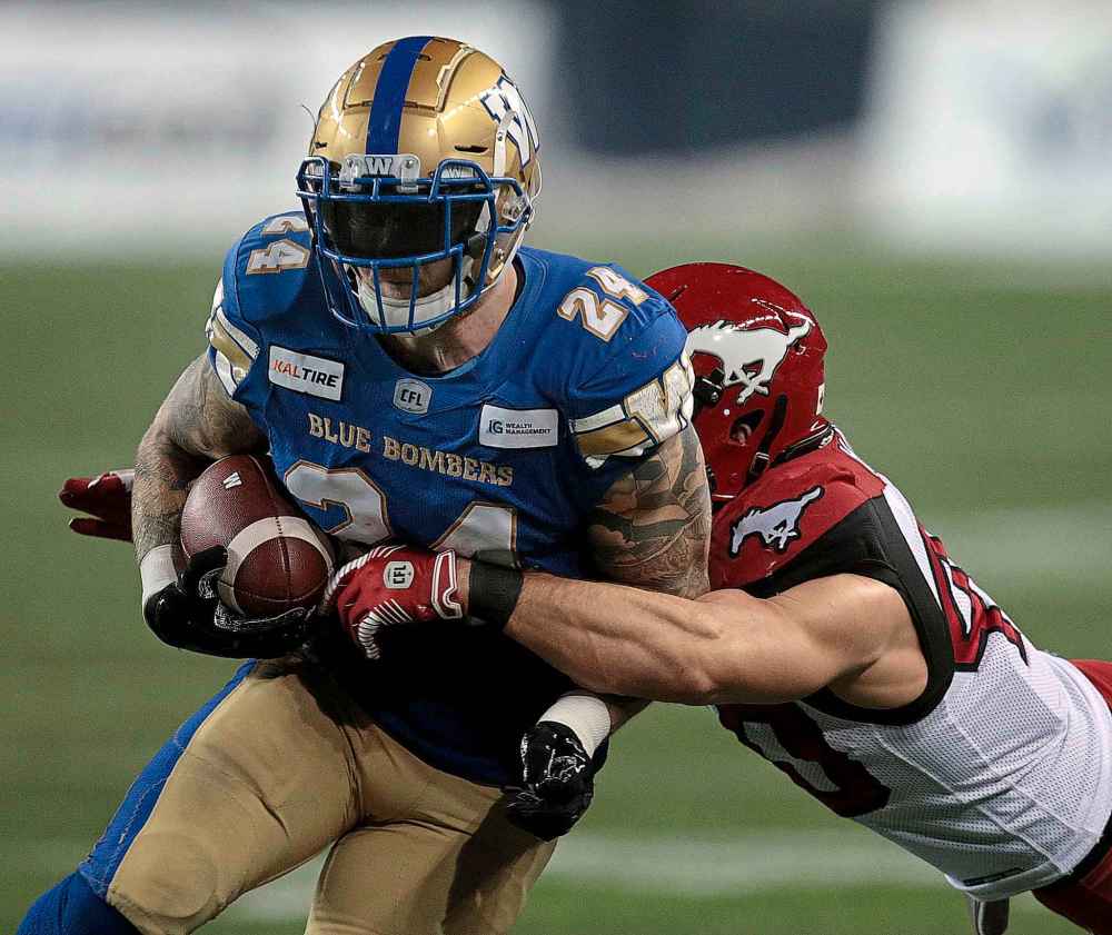 Phil Hossack / Winnipeg Free Press
Blue Bombers' fullback Mike Miller drives towards the goal line against the Stampeders' Nate Holley.
