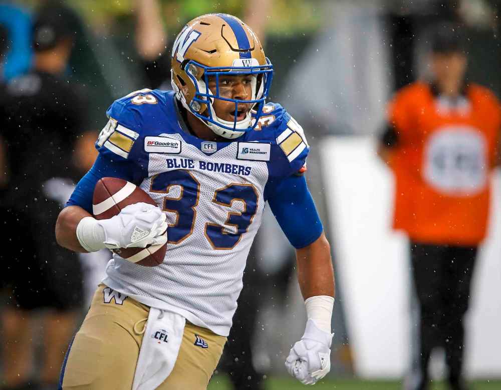 THE CANADIAN PRESS/Jeff McIntosh
Blue Bombers' Andrew Harris celebrates his touchdown during the first half in Edmonton, Friday.