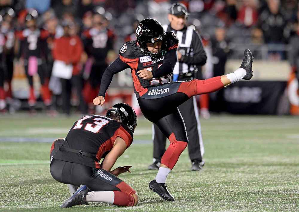 THE CANADIAN PRESS/Adrian Wyld
Ottawa Redblacks kicker Lewis Ward boots his 40th consecutive field goal setting a new league record Friday.