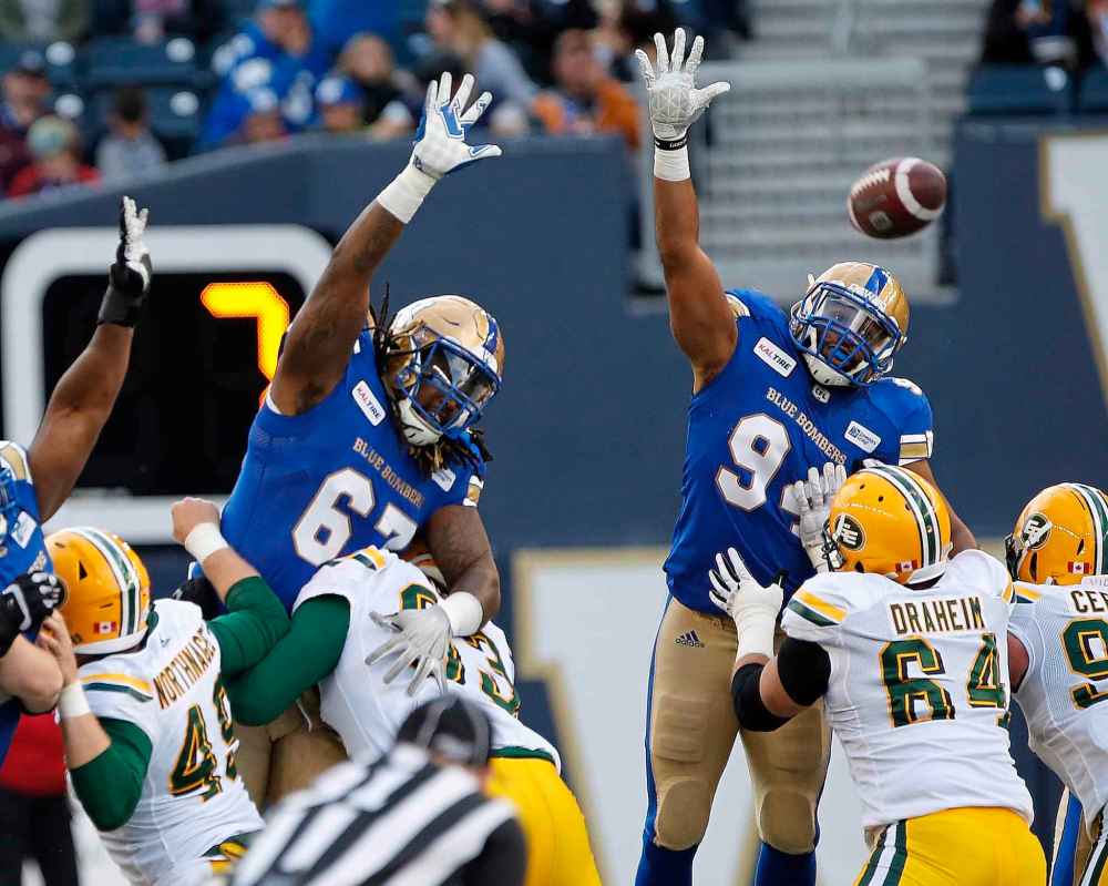 John Woods / The Canadian Press Files
Winnipeg Blue Bombers' Cory Johnson and Jackson Jeffcoat attempt to block the Edmonton Eskimos' field goal.