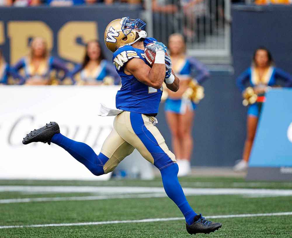 PHIL HOSSACK / WINNIPEG FREE PRESS
Winnipeg Blue Bombes' Nic Demski clutches the incoming pass and heads to the goal line scoring Winnipeg's first touchdown against the Toronto Argonauts Friday evening at Investors Group Field.