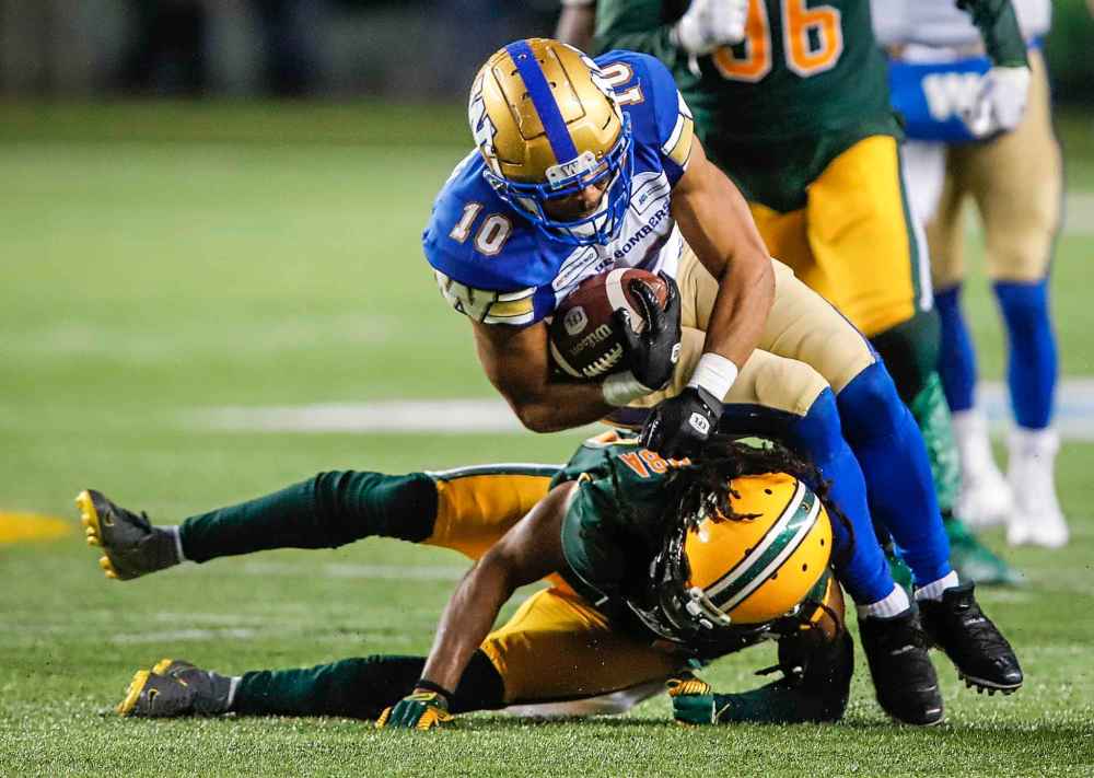 THE CANADIAN PRESS/Jeff McIntosh
Winnipeg Blue Bombers' Nic Demski, right, is tackled by Edmonton Eskimos' Don Unamba during the second half.