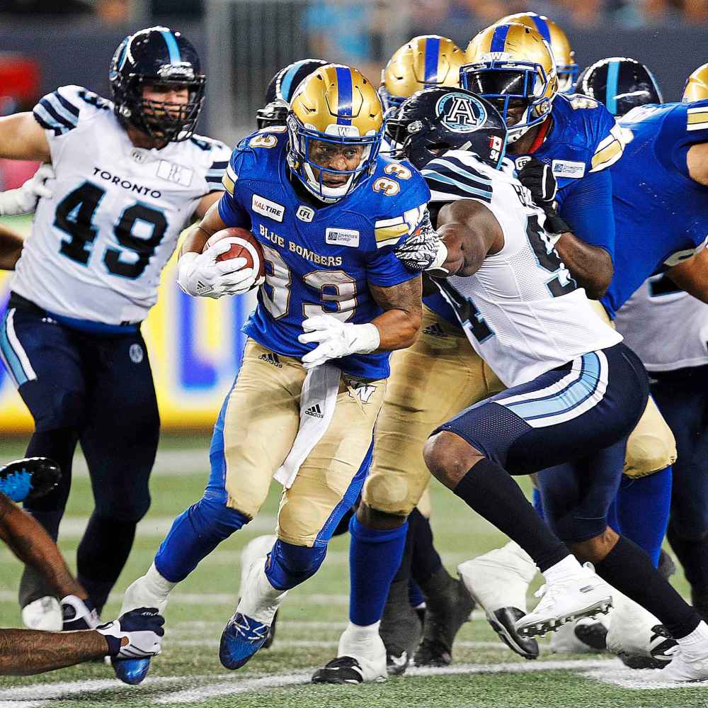 PHIL HOSSACK / WINNIPEG FREE PRESS
Bomber's Andrew Harris scampers around the Argonaut's defence Friday evening.