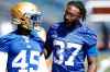 JOHN WOODS / WINNIPEG FREE PRESS
Blue Bombers halfback Brandon Alexander, right, gives words of advice to Elijah Battle at training camp in Winnipeg Monday.