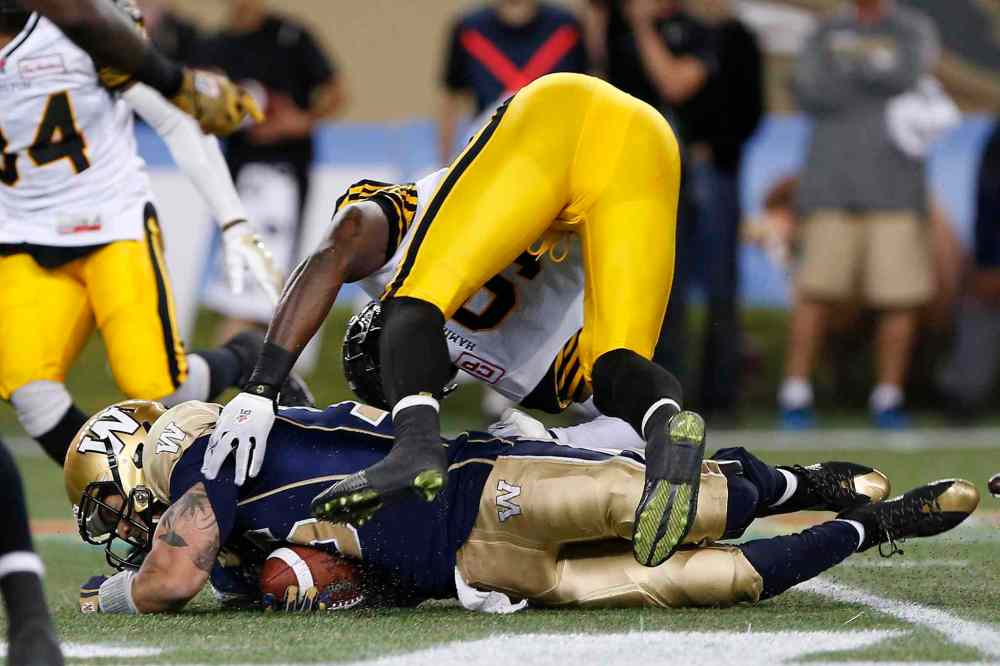 JOHN WOODS / CANADIAN PRESS
Winnipeg Blue Bombers' quarterback Robert Marve (16) runs for yards against Hamilton Tiger-Cats' Brandon Stewart (9) during the second half of CFL action in Winnipeg Friday.