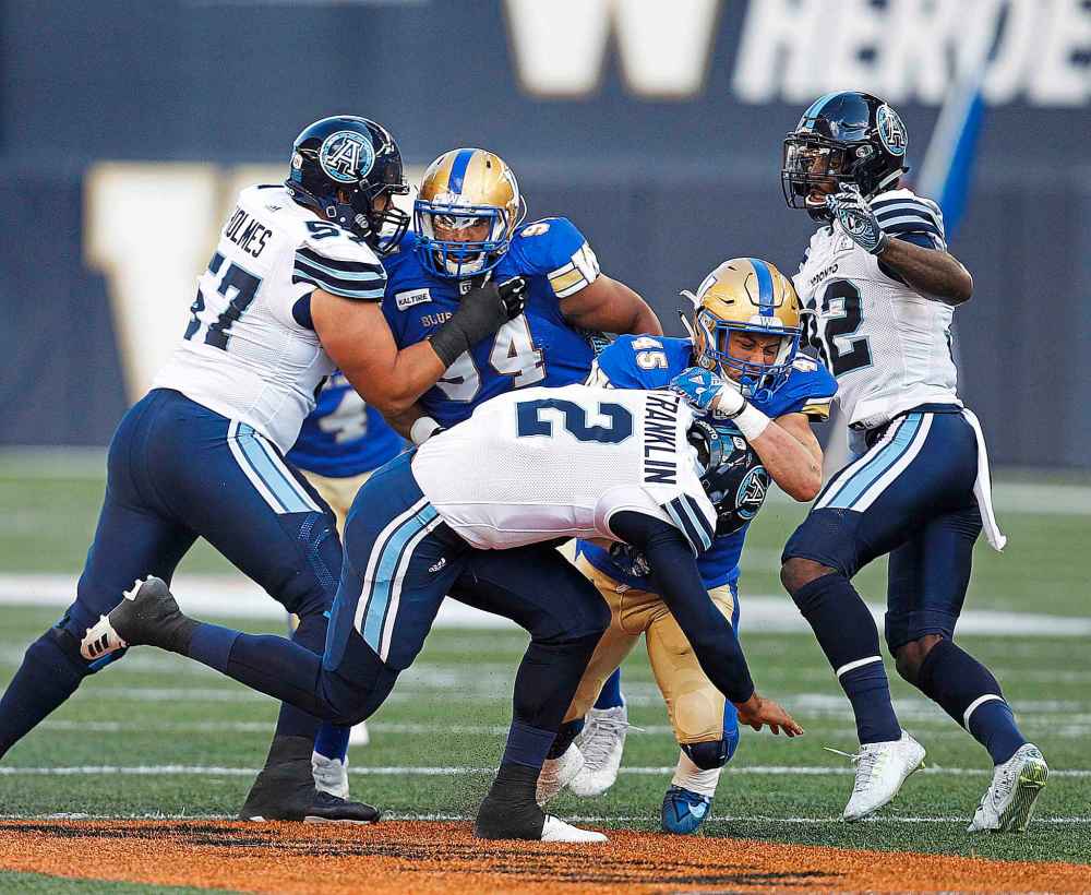 PHIL HOSSACK / WINNIPEG FREE PRESS
The Bombers Jovan Santos-Knox hauls down Toronto Argos QB James Franklin.
