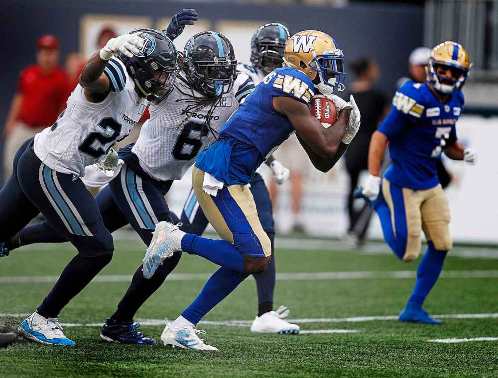 PHIL HOSSACK / WINNIPEG FREE PRESS
Latest Bombers' call-up Kenbrell Thompkins sprints away from Argonauts' Justin Tuggle and Marcus Ball.