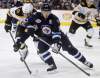 Trevor Hagan / The Canadian Press
Boston Bruins' Milan Lucic (17) and Winnipeg Jets' Tobias Enstrom (39) battle for the puck during first-period NHL hockey action in Winnipeg, Friday.
