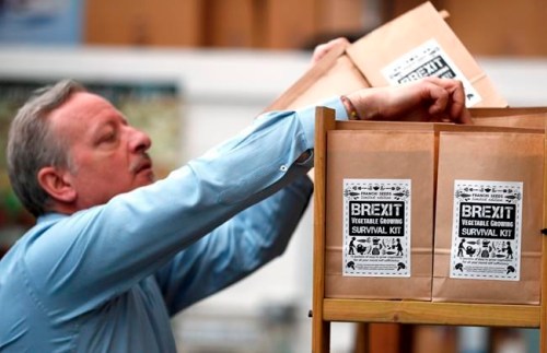 In this Monday, Feb. 25, 2019 photo, Paolo Arrigo of Seeds of Italy displays his Brexit Vegetable Growing Survival kit bags, at his company store in London. Arrigo put together 12 months‚Äô worth of easy-to-grow seed packets _ carrots, beans, lettuce, pumpkin, tomatoes _ and labelled it a Brexit Vegetable Growing Survival Kit. He has sold hundreds in a few weeks. (AP Photo/Frank Augstein)