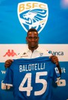 Italian soccer player Mario Balotelli holds a Brescia team jersey during a press conference, in Brescia, Italy, Monday, Aug. 19, 2019. Balotelli says his mother cried when he told her he was joining hometown club Brescia and insists he has no fear of failing on his return to Serie A after an absence of three years. (Filippo Venezia/ANSA via AP)