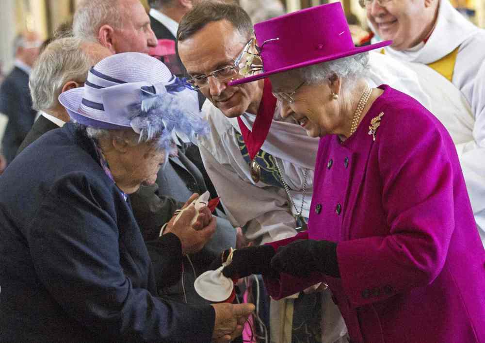 Jack Hill / The Associated Press
Britain's Queen Elizabeth II (right) speaks with pensioner Mrs Bradshaw during the Maundy Thursday service in Blackburn, England. Maundy Thursday is the Christian holy day falling on the Thursday before Easter. It commemorates the Maundy and Last Supper of Jesus Christ with the Apostles. The Queen commemorates Maundy by offering 'alms' to retired pensioners recommended by clergy and ministers of all denominations, in recognition of service to the church and to the local community.