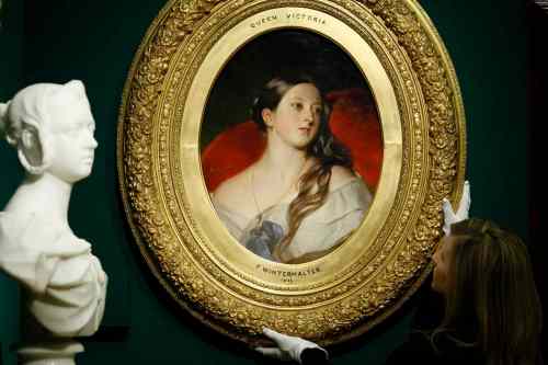 SANG TAN / The Associated Press Files
A member of the gallery staff adjusts a portrait of Queen Victoria by Franz Xaver Winterhalter at Buckingham Palace in London in 2010.