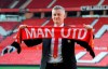Manchester United soccer team manager Ole Gunnar Solskaer holds a team scarf as he is unveiled as permanent Manchester United manager at Old Trafford, England, Thursday, March 28, 2019. Manchester United on Thursday, made coach Ole Gunnar Solskjaer a permanent hire, with a three-year contract. (AP Photo/Rui Vieira)