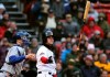 Boston Red Sox's Andrew Benintendi tosses his bat after striking out to end the seventh inning of the home opener baseball game against the Toronto Blue Jays, Tuesday, April 9, 2019, in Boston. At left is Blue Jays catcher Danny Jansen. (AP Photo/Charles Krupa)