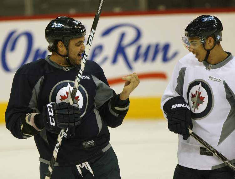 Joe Bryksa / Winnipeg Free Press
Winnipeg Jets Dustin Byfuglien, left, shows Evander Kane his finger during pregame workout Tuesday morning at the MTS Center in Winnipeg after coming off a injury.