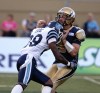 Trevor Hagan / Winnipeg Free Press
Bombers QB Buck Pierce takes one on the chin from the Brandon Isaac of the Argos on Saturday.