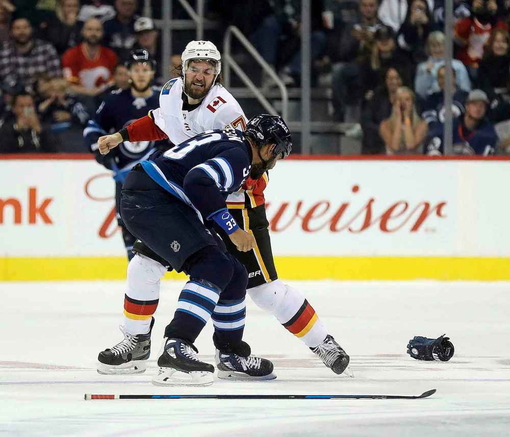 CP
Calgary Flames' Luke Gazdic (17) fights Winnipeg Jets' Dustin Byfuglien (33) during second period preseason NHL hockey action in Winnipeg, Monday, September 25, 2017. THE CANADIAN PRESS/Trevor Hagan