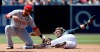 Cincinnati Reds second baseman Jose Peraza, left, tags out San Diego Padres' Fernando Tatis Jr. caught stealing during the third inning of a baseball game in San Diego, Sunday, April 21, 2019. (AP Photo/Alex Gallardo)