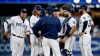 San Diego Padres pitching coach Darren Balsley, center, talks to starting pitcher Matt Strahm, second from left, and the infield during the first inning of a baseball game in San Diego, Monday, April 1, 2019. (AP Photo/Alex Gallardo)