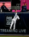 San Diego Padres right fielder Hunter Renfroe leaps but cannot reach a solo home run hit by Cincinnati Reds' Jesse Winker during the seventh inning of a baseball game in San Diego, Saturday, April 20, 2019. (AP Photo/Alex Gallardo)