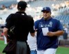 San Diego Padres interim manager Rod Barajas, right, meets with home plate umpire Alex Tosi before a baseball game against the Arizona Diamondbacks in San Diego, Saturday, Sept. 21, 2019. (AP Photo/Alex Gallardo)