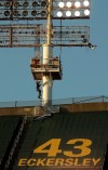 A technician climbs the left field lighting structure at the Oakland Coliseum in attempt to fix extinguished lights prior to the baseball game between the Cincinnati Reds and the Oakland Athletics on Tuesday, May 7, 2019, in Oakland, Calif. The game's start was delayed for work on the lights. (AP Photo/Ben Margot)