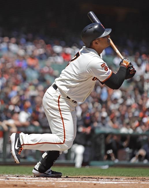 San Francisco Giants' Donovan Solano hits for an RBI sacrifice fly off Atlanta Braves' Kevin Gausman in the second inning of a baseball game Thursday, May 23, 2019, in San Francisco. (AP Photo/Ben Margot)