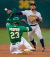 Houston Astros' Tony Kemp, right, throws over Oakland Athletics' Jurickson Profar (23) to complete a double play in the second inning of a baseball game Friday, May 31, 2019, in Oakland, Calif. Athletics' Ramon Laureano was out at first base. (AP Photo/Ben Margot)