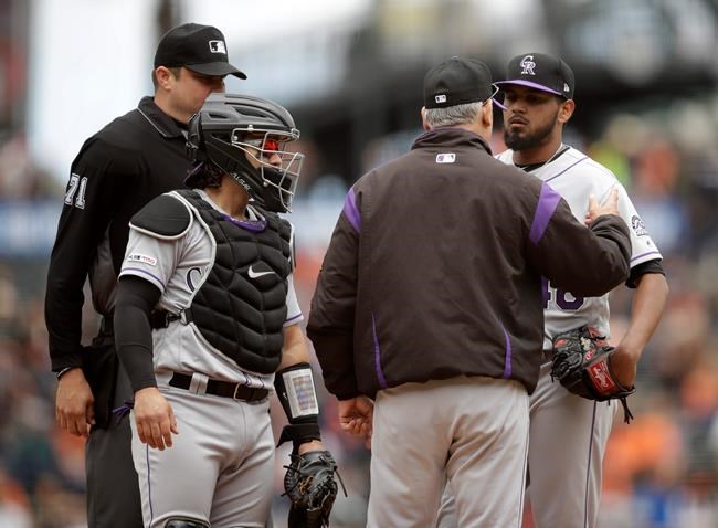 Colorado Rockies pitcher German Marquez, right, listens to manager Bud Black, second from right, in the first inning of a baseball game against the San Francisco Giants Wednesday, June 26, 2019, in San Francisco. (AP Photo/Ben Margot)