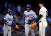 Los Angeles Dodgers third base coach Dino Ebel, left, reacts as David Freese (25) runs the bases after hitting a three run home run off San Francisco Giants' Drew Pomeranz, right, in the fourth inning of a baseball game Tuesday, April 30, 2019, in San Francisco. (AP Photo/Ben Margot)