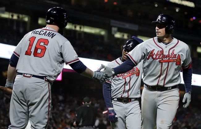Atlanta Braves' Austin Riley, right, is congratulated by Brian McCann (16) after hitting a three-run home run off San Francisco Giants' Derek Holland during the seventh inning of a baseball game Wednesday, May 22, 2019, in San Francisco. (AP Photo/Ben Margot)
