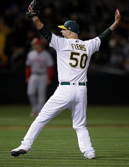 Oakland Athletics' Mike Fiers celebrates after pitching a no hitter against the Cincinnati Reds at the end of a baseball game Tuesday, May 7, 2019, in Oakland, Calif. (AP Photo/Ben Margot)
