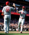 Philadelphia Phillies' Scott Kingery, right, is congratulated by J.T. Realmuto (10) after scoring against the San Francisco Giants in the third inning of a baseball game Sunday, Aug. 11, 2019, in San Francisco. (AP Photo/Ben Margot)