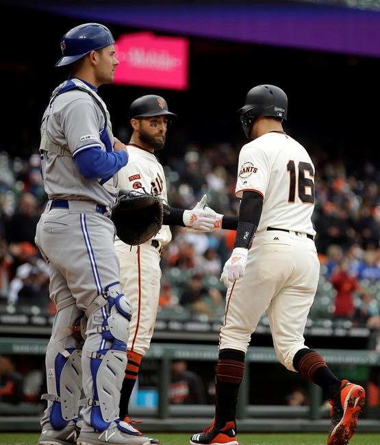 San Francisco Giants' Aramis Garcia (16) is congratulated by Kevin Pillar after hitting a two run home run off Toronto Blue Jays' Edwin Jackson in the second inning of a baseball game Wednesday, May 15, 2019, in San Francisco. At left is Toronto catcher Luke Maile. (AP Photo/Ben Margot)