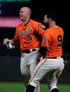 San Francisco Giants' Erik Kratz (5) and Brandon Belt, right, celebrate at the end of an 18 inning baseball game against the Colorado Rockies Saturday, April 13, 2019, in San Francisco. (AP Photo/Ben Margot)