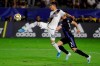 LA Galaxy midfielder Uriel Antuna, left, shoots next to Montreal Impact defender Daniel Lovitz during the second half of an MLS soccer match in Carson, Calif., Saturday, Sept. 21, 2019. (AP Photo/Chris Carlson)