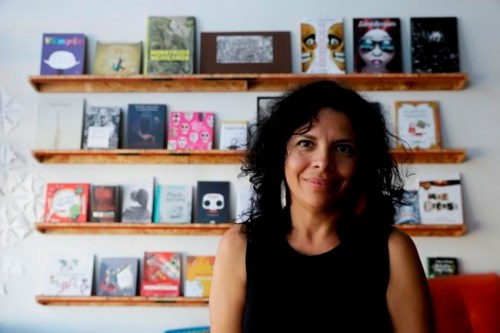 In this Saturday, Nov. 3, 2018, photo, Celene Navarette poses for a picture at La Libreria book store in Los Angeles. The market for Spanish books is growing but the traditional publishing industry has addressed demand in fits and starts. Three small companies have stepped in to fill the void, launched by three different pairs of Hispanic mothers frustrated by the dearth of Spanish-language books to reach to their children. They swiftly found demand from major retailers like Target and schools across the U.S. (AP Photo/Chris Carlson)
