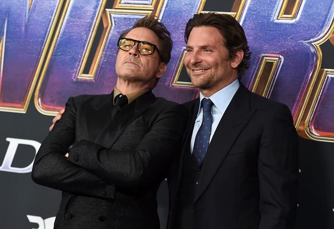 Robert Downey Jr., left, and Bradley Cooper arrive at the premiere of