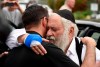 Rabbi Yisroel Goldstein, right, is hugged as he leaves a news conference at the Chabad of Poway synagogue, Sunday, April 28, 2019, in Poway, Calif. A man opened fire Saturday inside the synagogue near San Diego as worshippers celebrated the last day of a major Jewish holiday. (AP Photo/Denis Poroy)