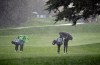 Si Woo Kim, left, of South Korea, and Scott Langley, right, walk in a hailstorm up the second fairway of the Pebble Beach Golf Links during the final round of the AT&T Pebble Beach Pro-Am golf tournament Sunday, Feb. 10, 2019, in Pebble Beach, Calif. Play was suspended after the storm. (AP Photo/Eric Risberg)