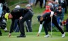 Wayne Gretzky, left, and Jordan Spieth, right, repair their marks on the 17th green of the Spyglass Hill Golf Course during the second round of the AT&T Pebble Beach Pro-Am golf tournament Friday, Feb. 8, 2019, in Pebble Beach, Calif. (AP Photo/Eric Risberg)