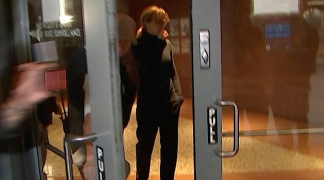In this still image taken from video, actress Felicity Huffman walks towards the door in the lobby of a Los Angeles court after she is released on a $250,000 bond, Tuesday, March 12, 2019. Huffman is among 50 people charged in a scheme in which wealthy parents allegedly bribed college coaches and other insiders to get their children into some of the nation's most selective schools. (AP Photo/Rick Taber)